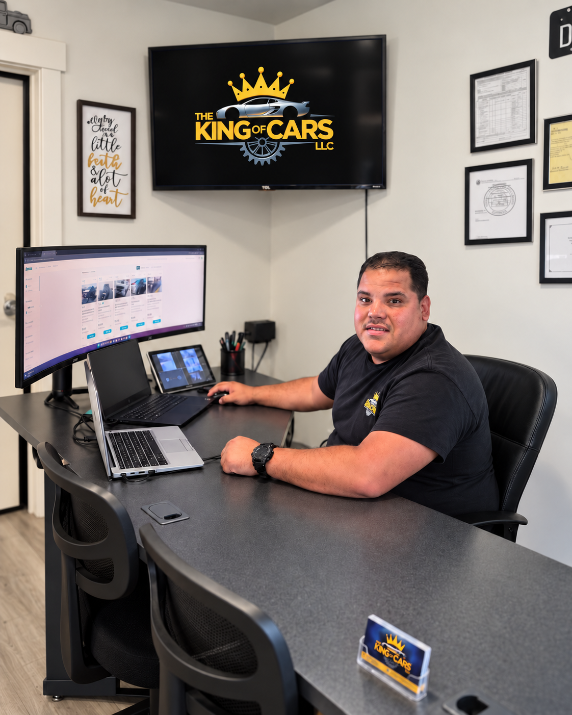 Daniel, owner of The King of Cars, at his desk at the dealership office in Springville, Utah